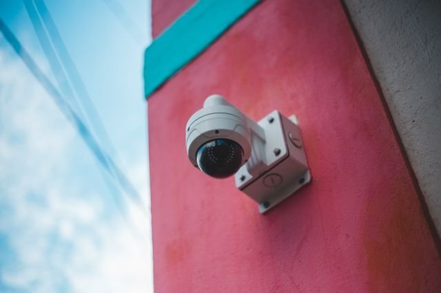 A security camera mounted on a wall.